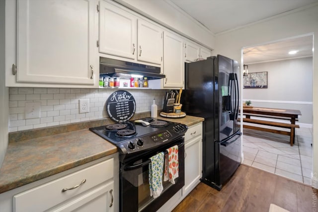 kitchen with black appliances, white cabinets, tasteful backsplash, and ornamental molding