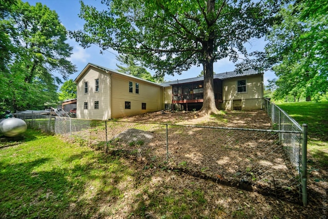 back of property featuring a sunroom and a yard