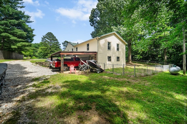 view of home's exterior featuring a carport and a yard