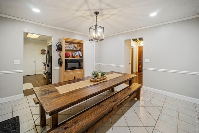 tiled dining space featuring ornamental molding