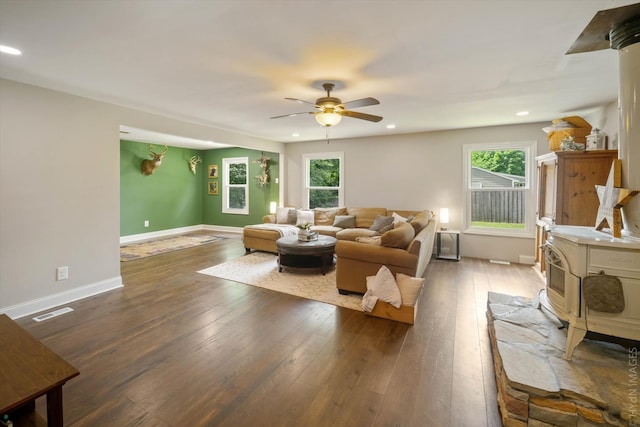 living room with ceiling fan, a wealth of natural light, and dark hardwood / wood-style flooring