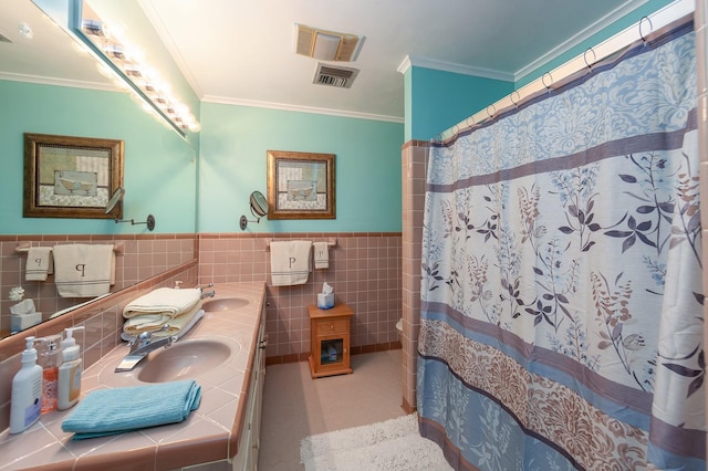 bathroom with vanity, tile walls, and crown molding