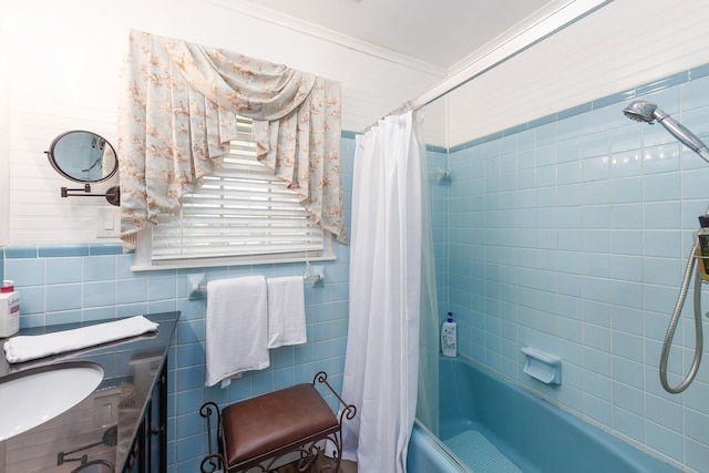 bathroom featuring crown molding, vanity, tile walls, and shower / bath combo with shower curtain