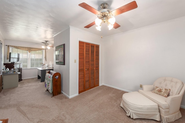 sitting room featuring ceiling fan, light colored carpet, and crown molding