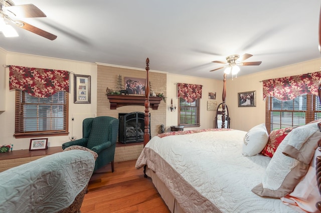 bedroom with ceiling fan, light hardwood / wood-style floors, and multiple windows