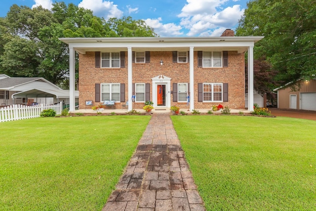 view of front of home with a front lawn and a carport