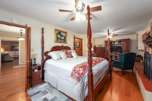 bedroom with ceiling fan, ornamental molding, and hardwood / wood-style flooring