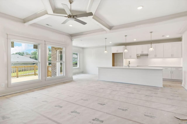 unfurnished living room featuring sink, ceiling fan, coffered ceiling, and beamed ceiling