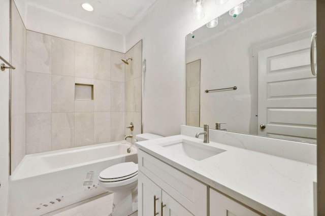 full bathroom with toilet, tiled shower / bath, and vanity