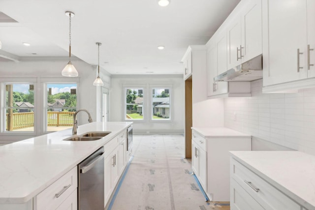 kitchen featuring sink, stainless steel appliances, white cabinetry, pendant lighting, and a kitchen island with sink