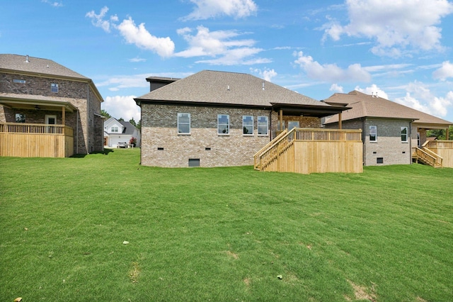 rear view of house featuring a yard