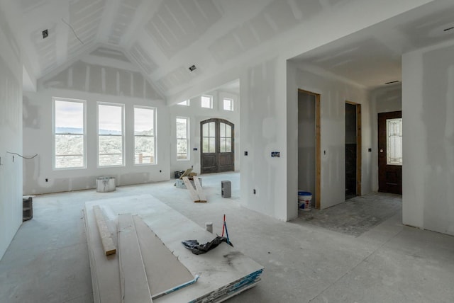 unfurnished room featuring high vaulted ceiling