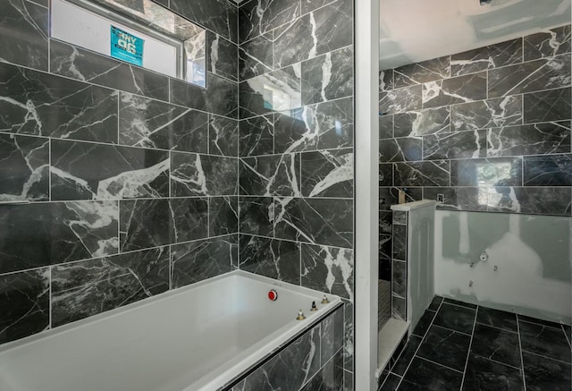 bathroom featuring tiled bath and tile walls