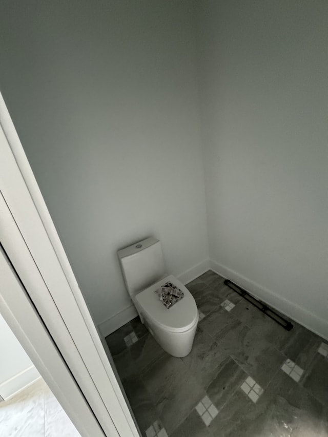 bathroom with toilet and tile patterned flooring