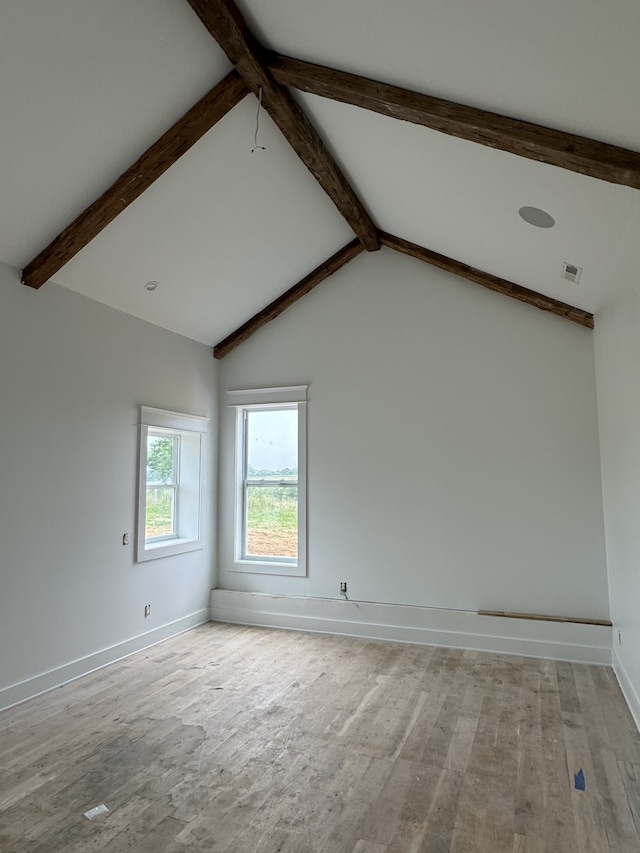 empty room with high vaulted ceiling, hardwood / wood-style flooring, and beam ceiling