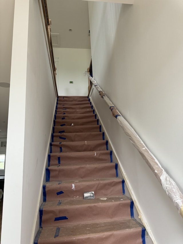 stairs featuring a towering ceiling