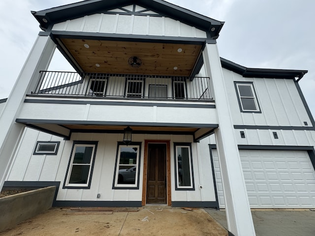 view of front of house featuring a balcony and a garage