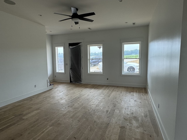 empty room featuring hardwood / wood-style flooring and ceiling fan