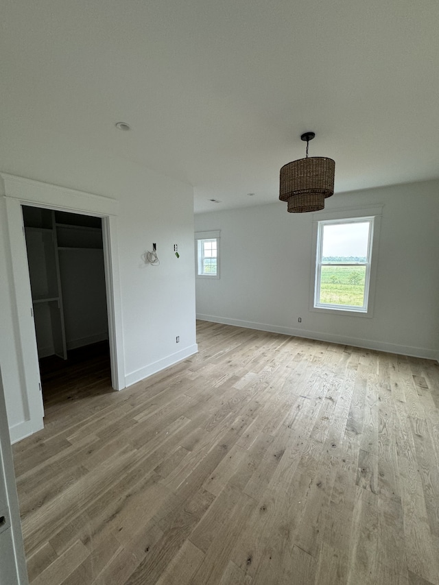 unfurnished bedroom with a closet and wood-type flooring