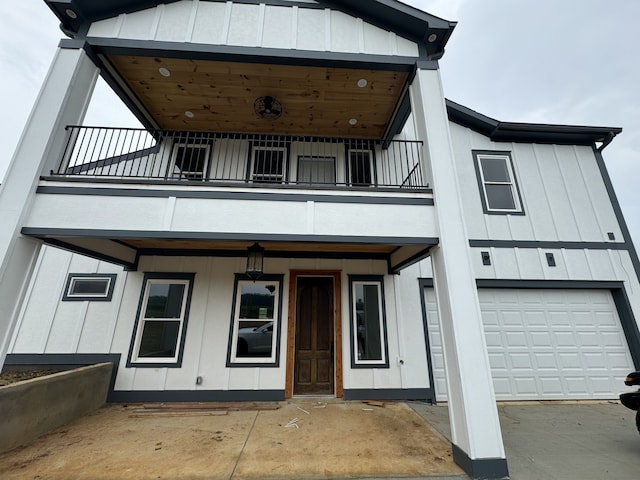 view of front of home featuring a balcony and a garage