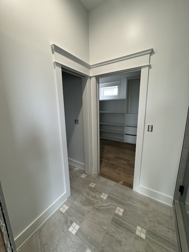 hallway with tile patterned flooring