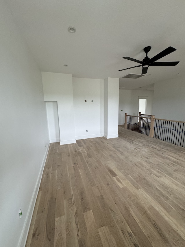 unfurnished living room with light hardwood / wood-style flooring and ceiling fan