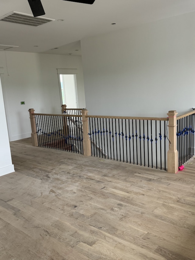 unfurnished room featuring ceiling fan and hardwood / wood-style floors