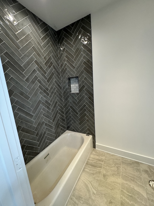 bathroom with tile patterned floors and tiled shower / bath combo