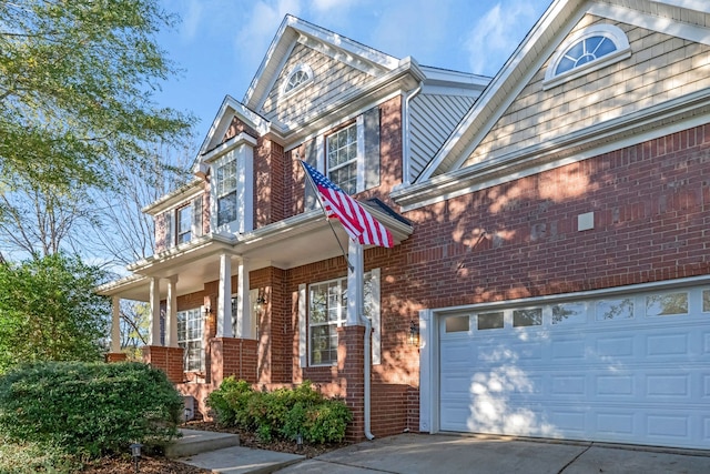 view of property with a porch and a garage