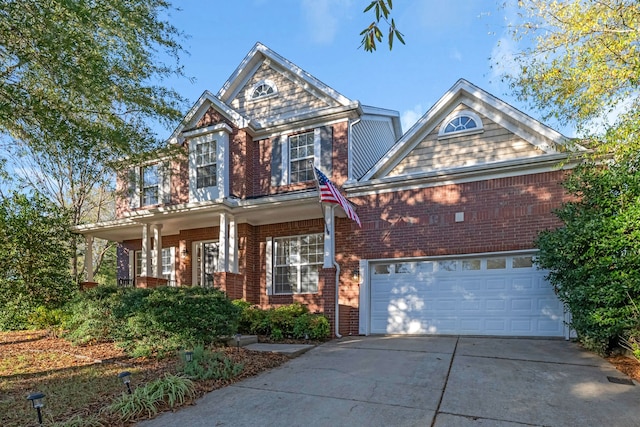 view of front of home featuring a porch and a garage