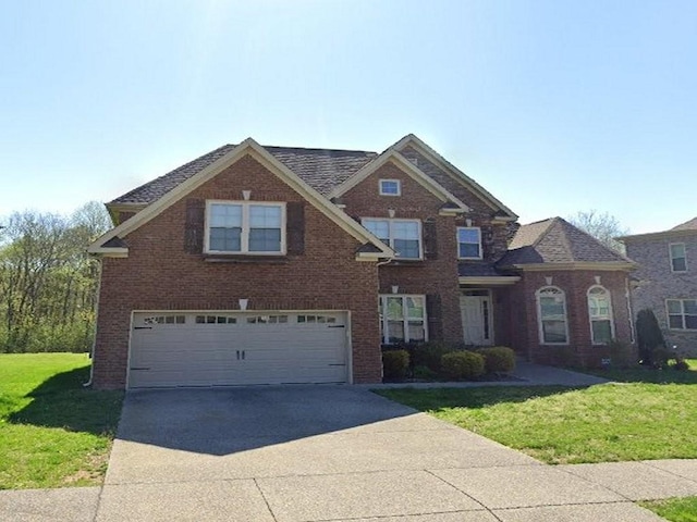 view of front facade featuring a garage and a front lawn