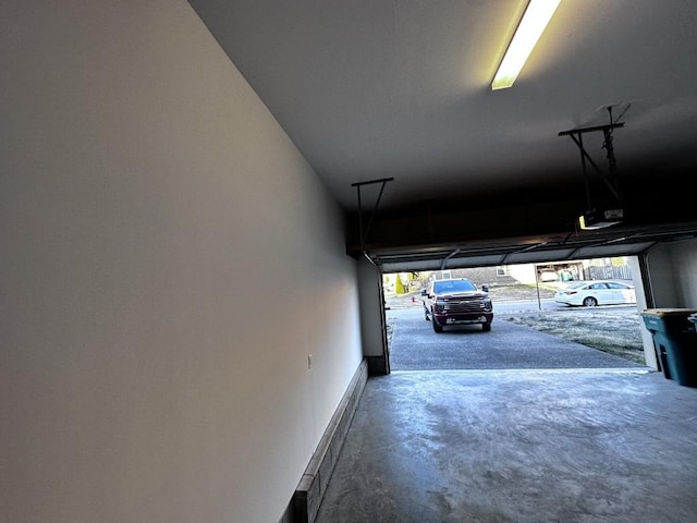 garage featuring baseboards and a garage door opener