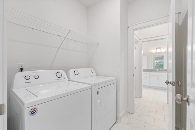 clothes washing area with washer and clothes dryer