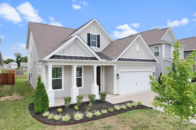 view of front of house with a garage, a front lawn, and a porch