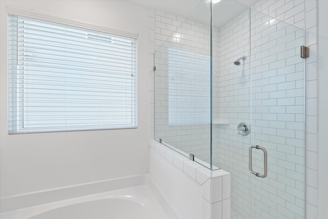 bathroom featuring separate shower and tub