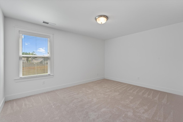 unfurnished room with light colored carpet