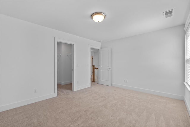 unfurnished room with light colored carpet