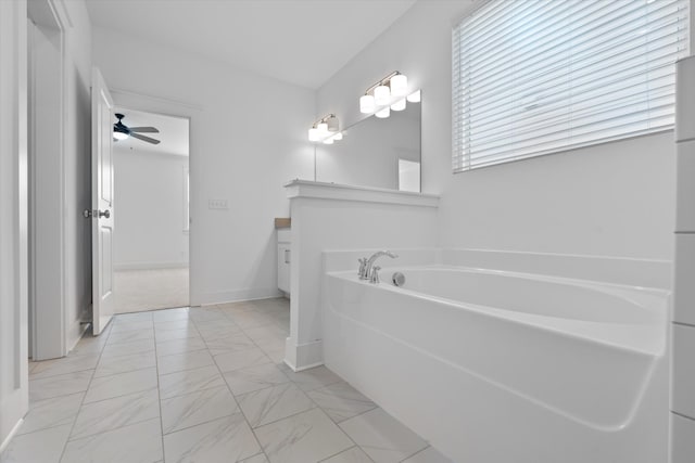 bathroom with vanity, a washtub, and ceiling fan