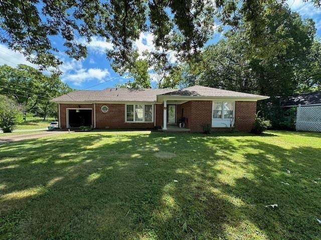 view of front of house with a garage and a front lawn