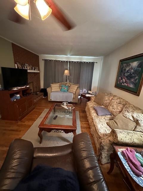 living room with hardwood / wood-style floors and ceiling fan