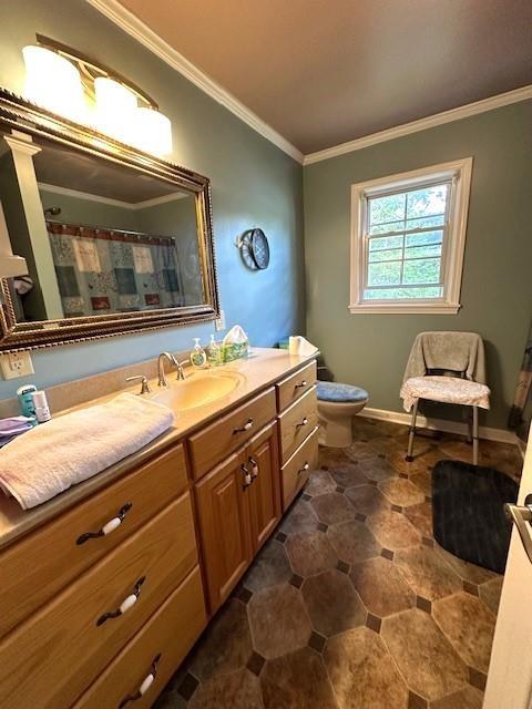 bathroom featuring crown molding, toilet, and vanity