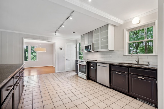 kitchen featuring white cabinetry, stainless steel appliances, sink, light tile patterned floors, and crown molding