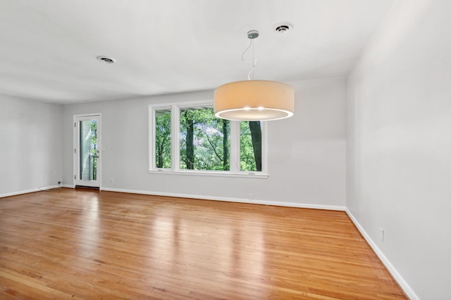 unfurnished room with hardwood / wood-style floors