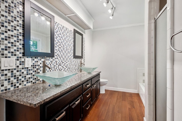 full bathroom with wood-type flooring, vanity, backsplash, toilet, and ornamental molding