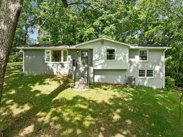 view of front of home featuring a front yard and cooling unit