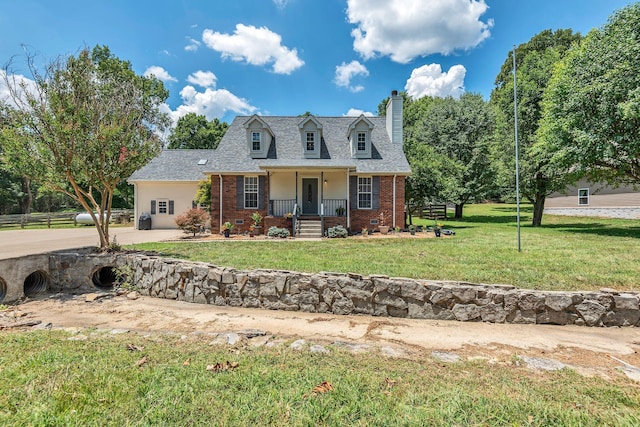 new england style home featuring a front lawn and a porch