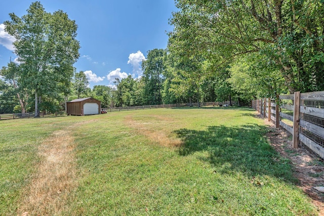 view of yard with a rural view and an outbuilding