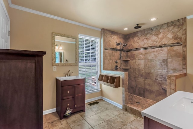 bathroom with vanity, tile patterned floors, ornamental molding, and a tile shower