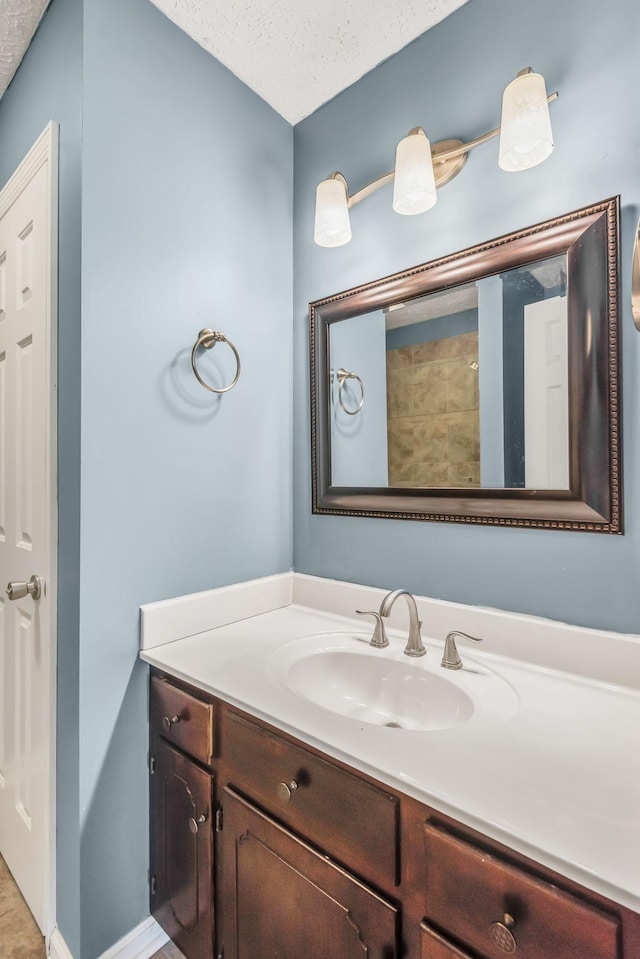 bathroom with vanity and a textured ceiling