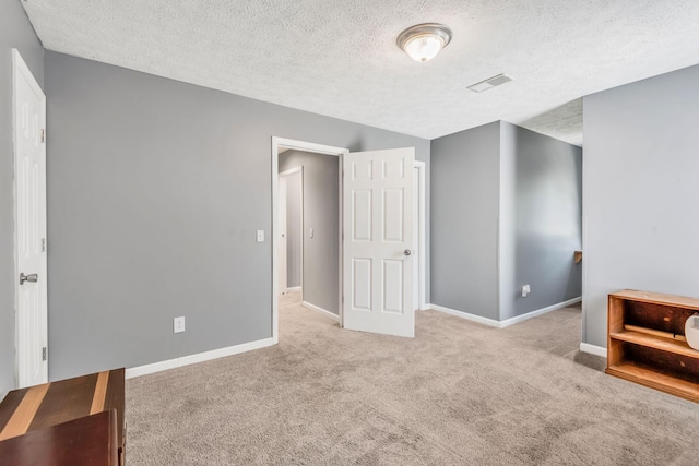 carpeted bedroom featuring a textured ceiling